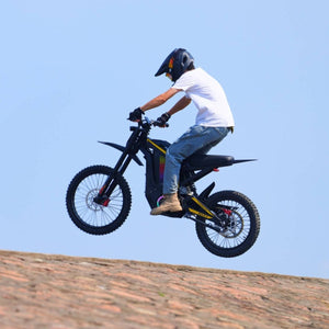 Rider airborne jumping on Freego Nova4 electric dirt bike against clear blue sky