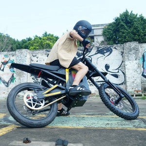 Rider making a tight turn on Freego Nova4 electric dirt bike in urban area