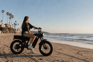 a girl riding freego f0 fat tire electric bike on the beach in california