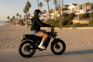 Girl riding Freego F0 fat tire electric bike along a beach road