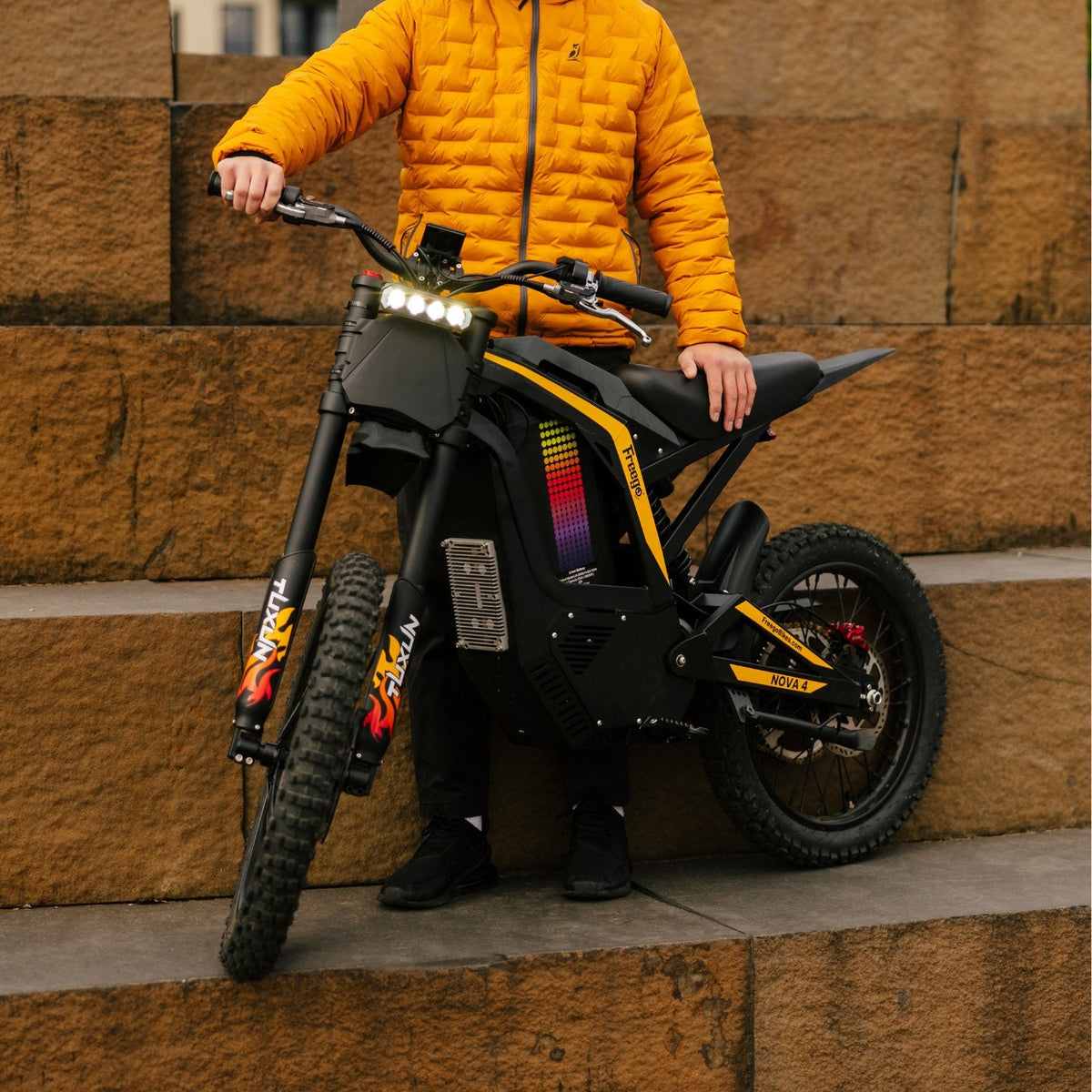 Freego Nova 4 electric dirt bike front angle with headlight on urban steps
