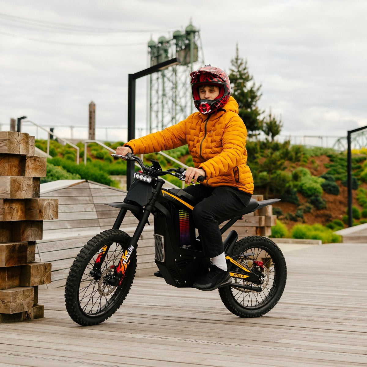 Freego Nova 4 electric dirt bike rider on wooden boardwalk in outdoor park