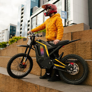 Freego Nova 4 electric dirt bike side view with rider on city steps